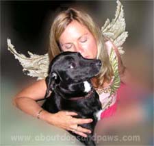 A dog rescue angel hugging a black dog